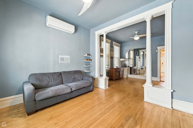 2240 S Avers Ave, Chicago, IL 60623 - living area with a ceiling fan, an AC wall unit, light wood-style flooring, and ornate columns