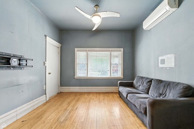 2240 S Avers Ave, Chicago, IL 60623 - living room with a wall unit AC, ceiling fan, and light wood finished floors
