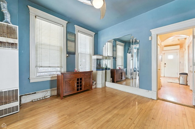 2240 S Avers Ave, Chicago, IL 60623 - spare room featuring a heating unit, arched walkways, ceiling fan, and hardwood / wood-style floors