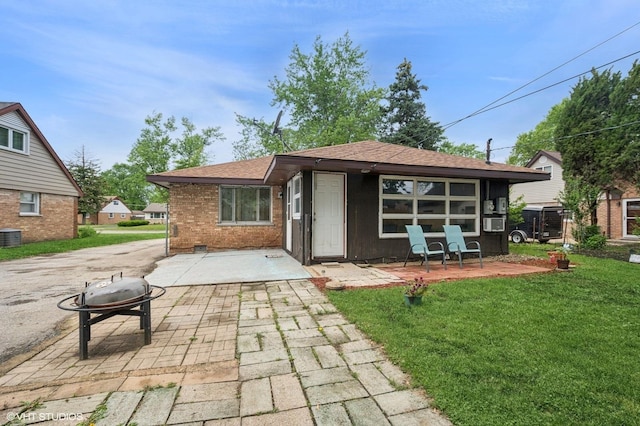 8937 Fairlane Dr, Bridgeview, IL 60455 - back of property with an outdoor fire pit, a patio area, a yard, brick siding, and a shingled roof