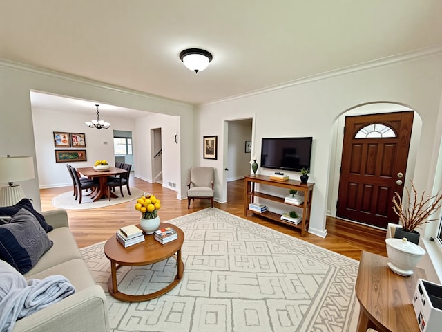 2111 N 75th Ct, Elmwood Park, IL 60707 - living area with crown molding, a chandelier, arched walkways, and wood finished floors