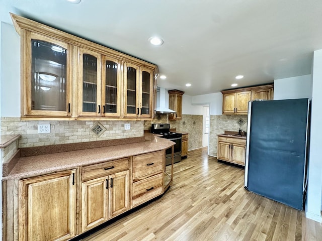 2111 N 75th Ct, Elmwood Park, IL 60707 - kitchen featuring electric range, freestanding refrigerator, wall chimney range hood, glass insert cabinets, and backsplash