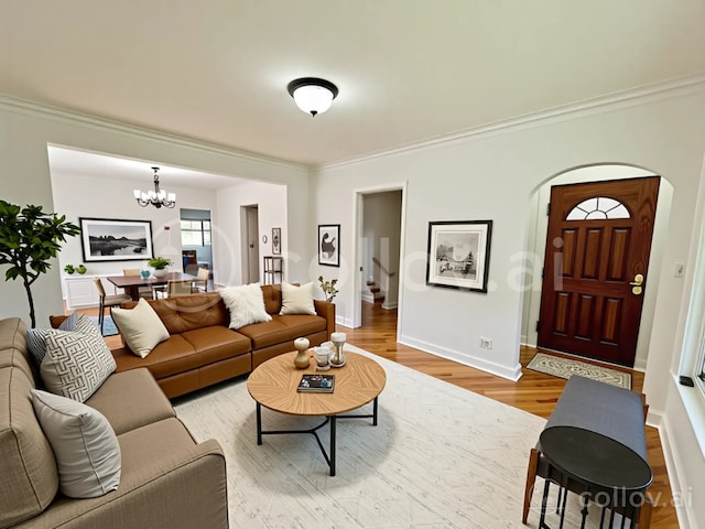 2111 N 75th Ct, Elmwood Park, IL 60707 - living room with ornamental molding, a chandelier, arched walkways, wood finished floors, and stairway