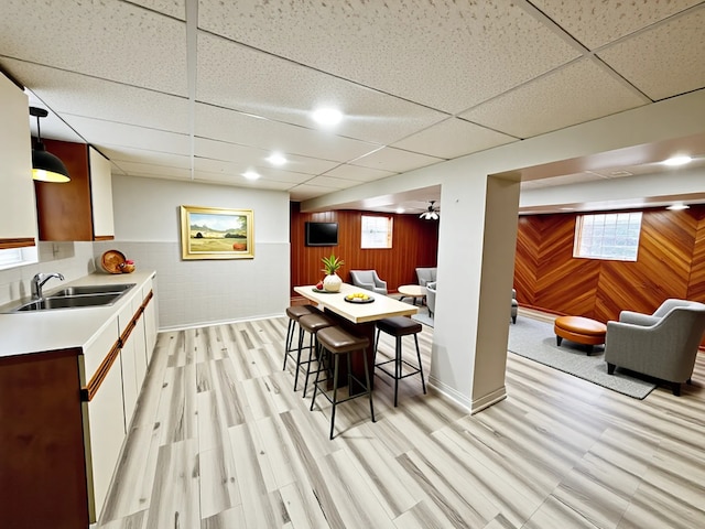 2111 N 75th Ct, Elmwood Park, IL 60707 - dining room with a drop ceiling, wood walls, and light wood-type flooring