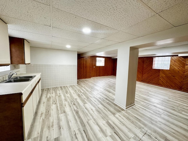 2111 N 75th Ct, Elmwood Park, IL 60707 - kitchen with wooden walls, light countertops, a drop ceiling, light wood-type flooring, and open floor plan