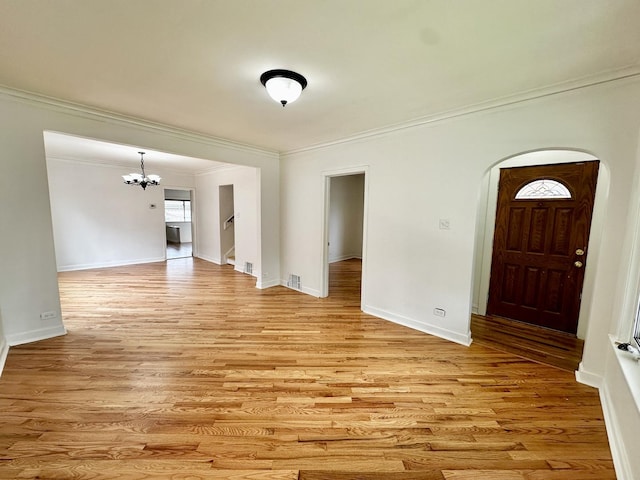 2111 N 75th Ct, Elmwood Park, IL 60707 - entrance foyer featuring a chandelier, crown molding, light wood finished floors, arched walkways, and stairway