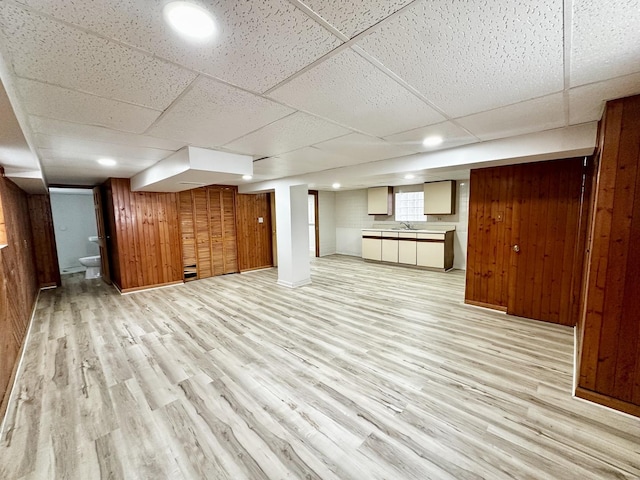 2111 N 75th Ct, Elmwood Park, IL 60707 - basement with light wood-style floors, wood walls, and a drop ceiling