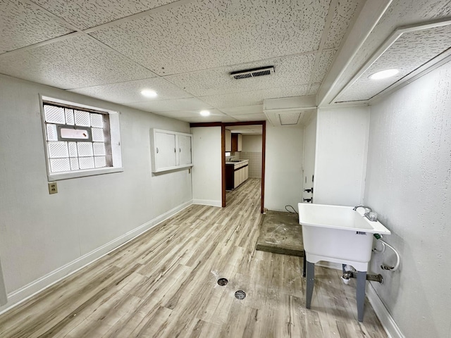 2111 N 75th Ct, Elmwood Park, IL 60707 - below grade area with light wood-style flooring and a paneled ceiling