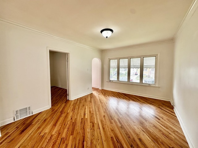 2111 N 75th Ct, Elmwood Park, IL 60707 - empty room featuring arched walkways, crown molding, and wood finished floors