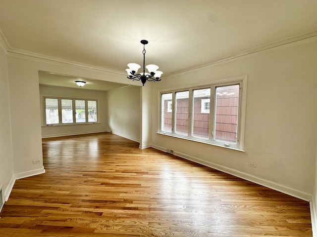 2111 N 75th Ct, Elmwood Park, IL 60707 - spare room with ornamental molding, a chandelier, and wood finished floors