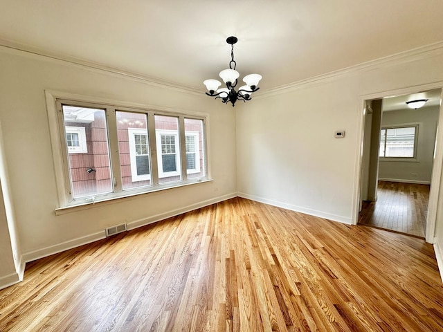 2111 N 75th Ct, Elmwood Park, IL 60707 - empty room featuring ornamental molding, a chandelier, and light wood-type flooring