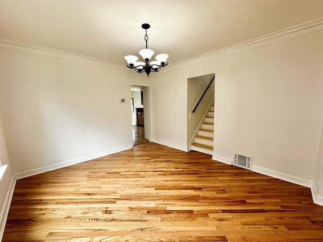 2111 N 75th Ct, Elmwood Park, IL 60707 - unfurnished dining area with a chandelier, crown molding, stairs, and light wood-style flooring