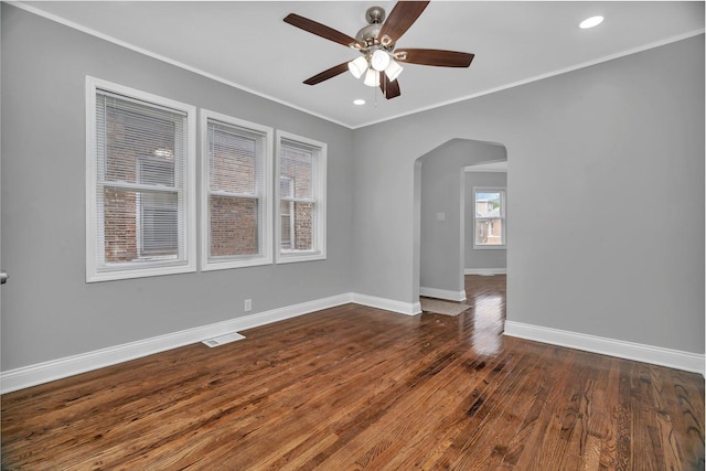 8107 S Princeton Ave, Chicago, IL 60620 - empty room featuring arched walkways, crown molding, a ceiling fan, dark wood-style flooring, and recessed lighting