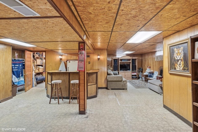 16645 Cottage Grove Ave, South Holland, IL 60473 - living room with wood walls, a dry bar, and tile patterned floors