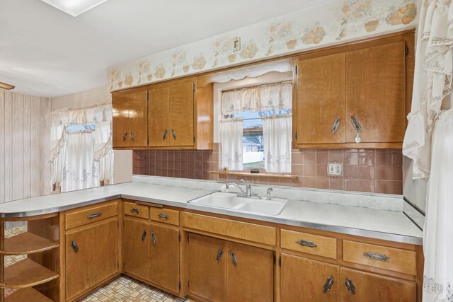 16645 Cottage Grove Ave, South Holland, IL 60473 - kitchen featuring light countertops, plenty of natural light, brown cabinetry, and tasteful backsplash