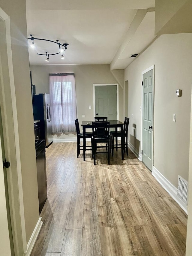 2122 N Lorel Ave, Chicago, IL 60639 - dining space with light wood-type flooring and rail lighting