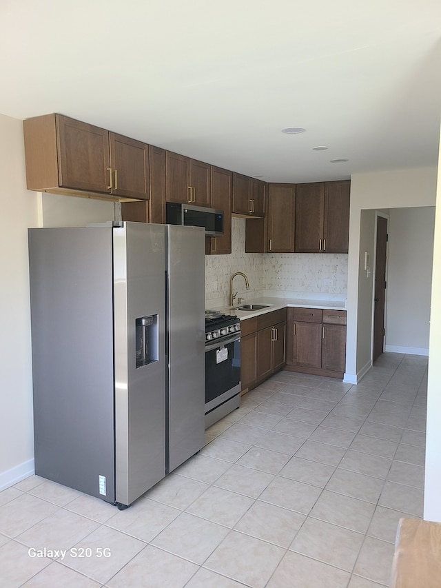 18550 Torrence Ave Unit 25, Lansing, IL 60438 - kitchen featuring stainless steel appliances, light countertops, dark brown cabinetry, and light tile patterned flooring