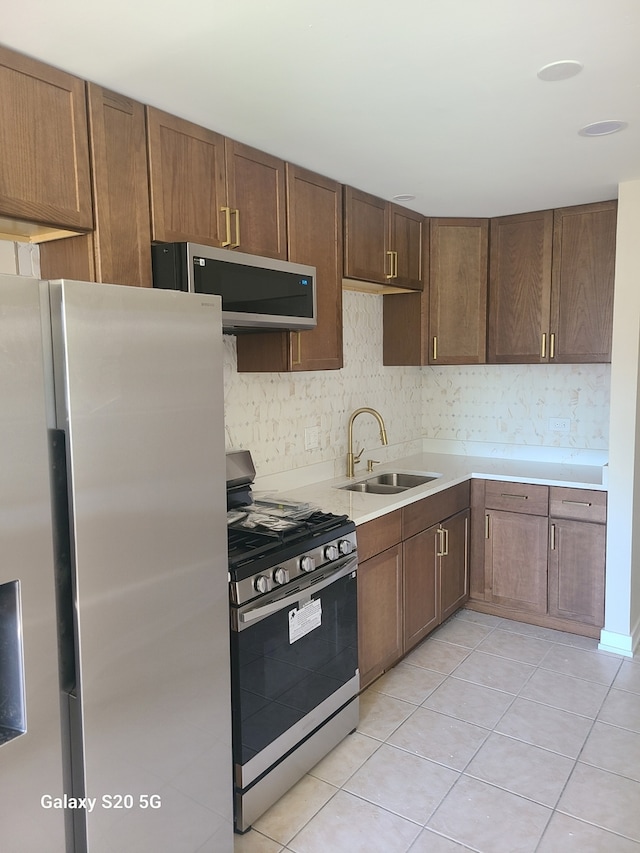 18550 Torrence Ave Unit 25, Lansing, IL 60438 - kitchen featuring stainless steel appliances, light tile patterned floors, light countertops, and decorative backsplash
