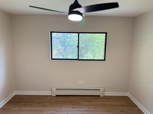 18550 Torrence Ave Unit 25, Lansing, IL 60438 - unfurnished room with a baseboard heating unit and wood finished floors