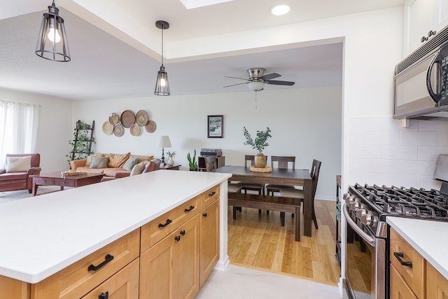110 W Butterfield Rd Unit 503S, Elmhurst, IL 60126 - kitchen with stainless steel appliances, open floor plan, light countertops, decorative light fixtures, and backsplash