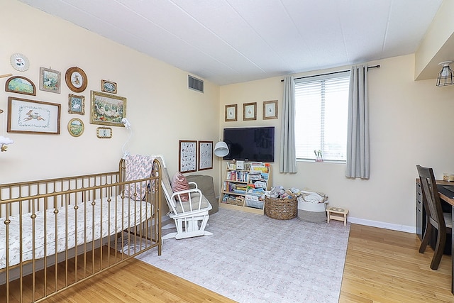 110 W Butterfield Rd Unit 503S, Elmhurst, IL 60126 - bedroom featuring wood finished floors and a nursery area