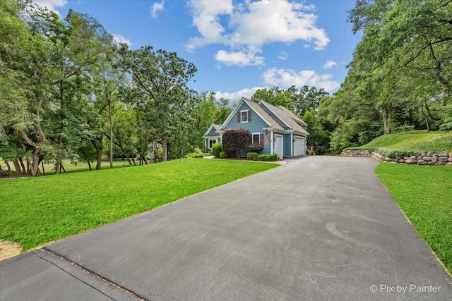 6407 Kingsbridge Dr, Cary, IL 60013 - view of front of property with asphalt driveway, a front lawn, view of scattered trees, and a garage