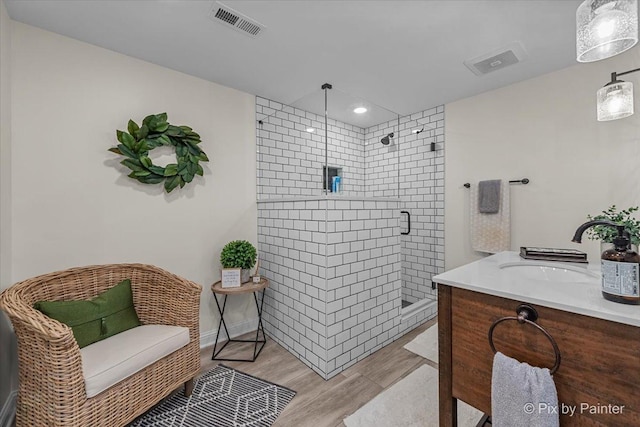 6407 Kingsbridge Dr, Cary, IL 60013 - full bathroom featuring a shower stall, wood finished floors, vanity, and recessed lighting