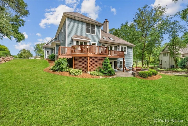 6407 Kingsbridge Dr, Cary, IL 60013 - back of property featuring a deck, a yard, a chimney, and a patio