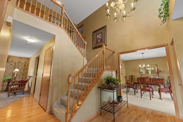 12 White Oak Ct, Algonquin, IL 60102 - stairs with a chandelier, wood finished floors, and a towering ceiling