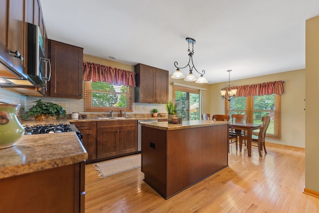 12 White Oak Ct, Algonquin, IL 60102 - kitchen featuring tasteful backsplash, appliances with stainless steel finishes, a center island, hanging light fixtures, and light wood-type flooring