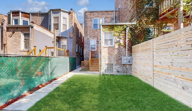4450 S Prairie Ave, Chicago, IL 60653 - rear view of house featuring brick siding and a fenced backyard