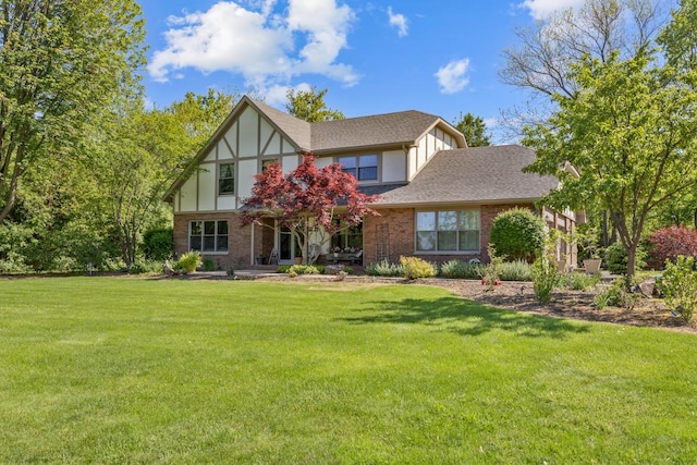 21326 N Elder Ct, Kildeer, IL 60047 - tudor home featuring a front yard, a shingled roof, and brick siding