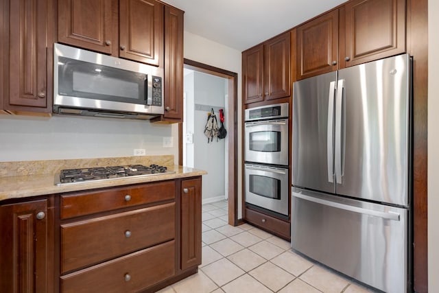 21326 N Elder Ct, Kildeer, IL 60047 - kitchen featuring appliances with stainless steel finishes, light tile patterned floors, and light stone countertops