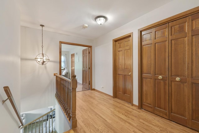 21326 N Elder Ct, Kildeer, IL 60047 - hall featuring an upstairs landing, light wood finished floors, and a chandelier