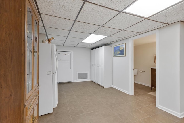 21326 N Elder Ct, Kildeer, IL 60047 - below grade area with a drop ceiling, freestanding refrigerator, and light tile patterned floors