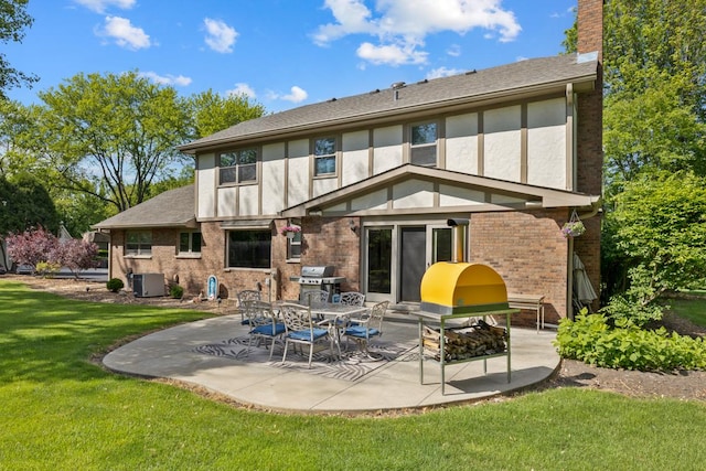 21326 N Elder Ct, Kildeer, IL 60047 - back of house featuring a patio, a lawn, a chimney, brick siding, and stucco siding
