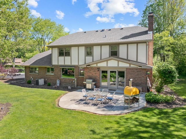 21326 N Elder Ct, Kildeer, IL 60047 - back of house featuring a patio, brick siding, a chimney, and a lawn