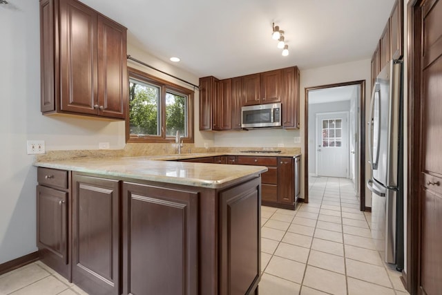 21326 N Elder Ct, Kildeer, IL 60047 - kitchen with stainless steel appliances, a peninsula, light tile patterned flooring, and light stone countertops
