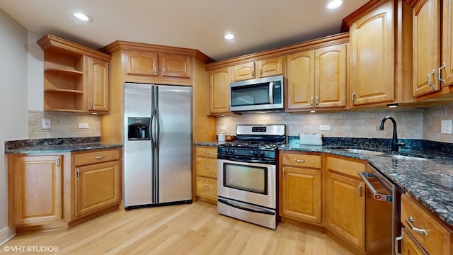 6333 N Milwaukee Ave Unit 2E, Chicago, IL 60646 - kitchen with appliances with stainless steel finishes, open shelves, light wood-style flooring, dark stone countertops, and recessed lighting