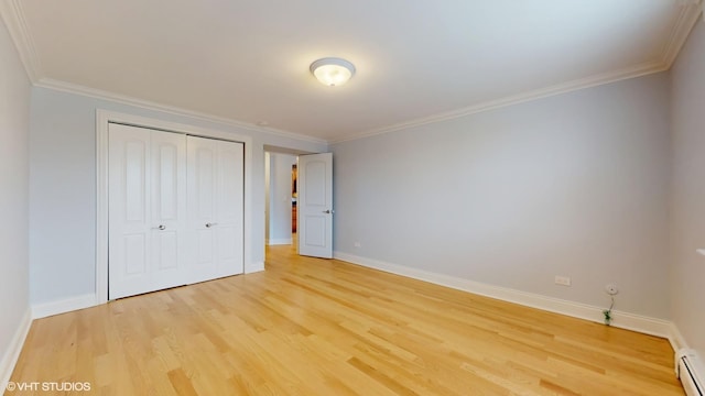 6333 N Milwaukee Ave Unit 2E, Chicago, IL 60646 - unfurnished bedroom with light wood-style flooring, a baseboard heating unit, a closet, and crown molding