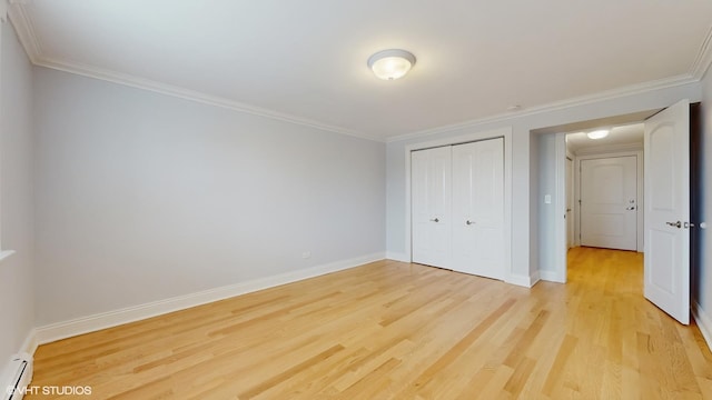 6333 N Milwaukee Ave Unit 2E, Chicago, IL 60646 - unfurnished bedroom with light wood-style flooring, a baseboard heating unit, ornamental molding, and a closet