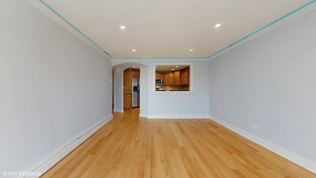 6333 N Milwaukee Ave Unit 2E, Chicago, IL 60646 - unfurnished living room with a baseboard heating unit, arched walkways, light wood-style flooring, recessed lighting, and crown molding
