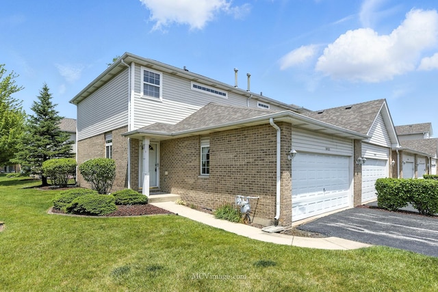 8422 Stratford Dr Unit 8422, Tinley Park, IL 60487 - view of front of house with an attached garage, brick siding, driveway, a front yard, and a shingled roof