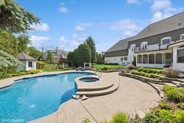 301 E 59th St, Hinsdale, IL 60521 - outdoor pool featuring a playground, a patio, an in-ground hot tub, a sunroom, and an outbuilding