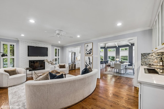 301 E 59th St, Hinsdale, IL 60521 - living room featuring crown molding, a fireplace, a ceiling fan, dark wood-style floors, and recessed lighting
