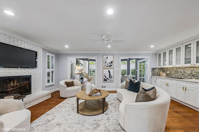 301 E 59th St, Hinsdale, IL 60521 - living room with ornamental molding, dark wood-style floors, a ceiling fan, a brick fireplace, and recessed lighting