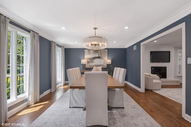 301 E 59th St, Hinsdale, IL 60521 - dining space featuring ornamental molding, wood finished floors, a chandelier, a fireplace, and recessed lighting