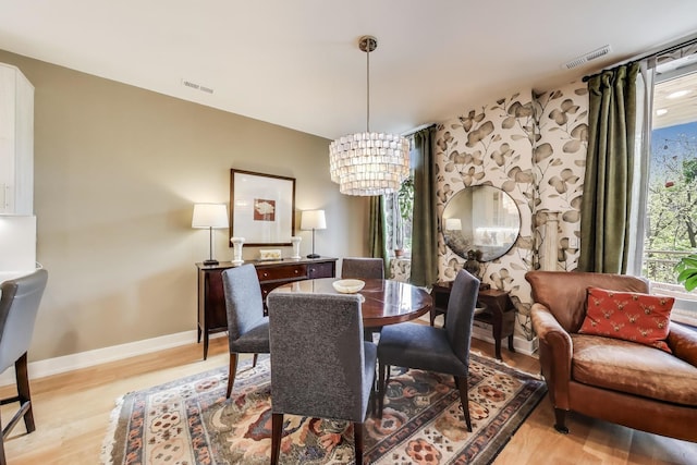 1346 W Sunnyside Ave Unit 2A, Chicago, IL 60640 - dining room with a chandelier and light wood-type flooring