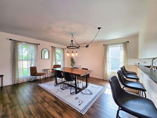 2440 Pebblewood Ct, Aurora, IL 60506 - dining room featuring healthy amount of natural light, dark wood finished floors, and a chandelier
