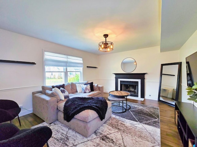 2440 Pebblewood Ct, Aurora, IL 60506 - living room featuring wood finished floors, a fireplace, and a chandelier